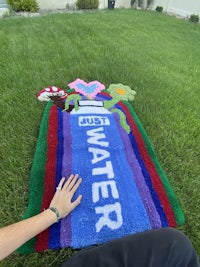 a person is laying on a rug with the word water on it